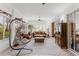 Open sunroom featuring tile flooring, a hanging chair, and comfortable leather seating at 2173 Caledonian St, Clermont, FL 34711