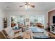 Bright living room boasts ceiling fan, neutral paint, and sliding glass doors to outdoor space at 2173 Caledonian St, Clermont, FL 34711