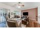 Inviting living room featuring hardwood floors, ceiling fan, cozy seating, and sliding glass doors to lanai at 2173 Caledonian St, Clermont, FL 34711