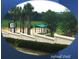 Community softball field behind a white wall with palm trees offering shade at 2173 Caledonian St, Clermont, FL 34711