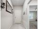 Inviting hallway with neutral tones, tiled floors, and access to various rooms in the home at 220 Foxtail Loop, Davenport, FL 33837