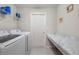 Laundry room with washer, dryer, ample counter space, and storage shelving at 220 Foxtail Loop, Davenport, FL 33837