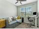Bright bedroom featuring a trundle daybed, desk, ceiling fan, and large window with blinds at 2491 Wadeview Loop, St Cloud, FL 34769