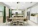 Bright dining area featuring a modern chandelier and views of the updated kitchen at 2491 Wadeview Loop, St Cloud, FL 34769