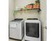 Laundry room with a modern washer and dryer, and wire rack for storage at 2491 Wadeview Loop, St Cloud, FL 34769