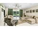 Spacious living room with a large sectional sofa and access to the screened patio at 2491 Wadeview Loop, St Cloud, FL 34769