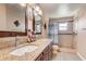 Bathroom featuring double sinks, granite countertops and a tiled shower at 2800 Woodsmere Ct, Kissimmee, FL 34746