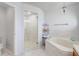 Bathroom showcasing a glass shower, a tub with tiled surround and fixtures at 2800 Woodsmere Ct, Kissimmee, FL 34746