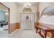 Grand foyer with tile flooring, high ceilings, decorative chandelier, and console table at 2800 Woodsmere Ct, Kissimmee, FL 34746