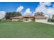 Charming single-story home featuring a spacious lawn, screened porch, and attached two-car garage at 2800 Woodsmere Ct, Kissimmee, FL 34746