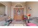 Welcoming front porch with seating, decor, and double doors with decorative glass at 2800 Woodsmere Ct, Kissimmee, FL 34746