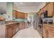 Traditional kitchen featuring tile flooring, wood cabinets, granite countertops and stainless steel appliances at 2800 Woodsmere Ct, Kissimmee, FL 34746