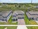 Aerial view of the two-story home showcasing well-manicured lawns and a brick paved driveway at 3179 Sailing Pier Ave, Winter Garden, FL 34787