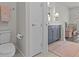 Neutral bathroom featuring a toilet, gray vanity, and decor at 3179 Sailing Pier Ave, Winter Garden, FL 34787