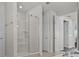 Bright bathroom featuring a glass-enclosed shower with bench, creating a luxurious and modern space at 3179 Sailing Pier Ave, Winter Garden, FL 34787