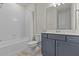 Clean bathroom features a tub, shower, and vanity with lots of storage at 3179 Sailing Pier Ave, Winter Garden, FL 34787