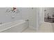 Bright bathroom featuring a built-in white tub with princess wall art at 3179 Sailing Pier Ave, Winter Garden, FL 34787