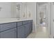 Bright bathroom featuring a gray vanity with double sinks at 3179 Sailing Pier Ave, Winter Garden, FL 34787