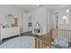 Bedroom with pastel rug and white dresser, creating a sweet and comfortable space at 3179 Sailing Pier Ave, Winter Garden, FL 34787