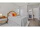 Bright bedroom featuring a white bed with colorful pillows, a closet and ensuite bathroom at 3179 Sailing Pier Ave, Winter Garden, FL 34787