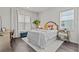 Bright bedroom featuring a white bed with colorful pillows, a desk, and natural light from the window at 3179 Sailing Pier Ave, Winter Garden, FL 34787