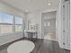 Bright bedroom featuring hardwood floors, a makeup vanity with lights, and an ensuite bathroom entrance at 3179 Sailing Pier Ave, Winter Garden, FL 34787