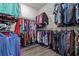 Well-organized walk-in closet filled with a variety of clothing, maximizing storage space at 3179 Sailing Pier Ave, Winter Garden, FL 34787
