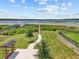 Aerial view of a community park featuring a wooden pier that extends onto the lake at 3179 Sailing Pier Ave, Winter Garden, FL 34787