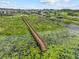 A long wooden pier extends onto the lake from the community park and walking path at 3179 Sailing Pier Ave, Winter Garden, FL 34787
