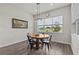 Cozy dining area features wood table, chairs, natural lighting, and an attractive window view at 3179 Sailing Pier Ave, Winter Garden, FL 34787