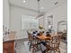 Bright dining room featuring a dark wood table, decor, and natural light from a window at 3179 Sailing Pier Ave, Winter Garden, FL 34787