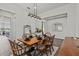 Bright dining room featuring a dark wood table, decor, and a vintage chandelier at 3179 Sailing Pier Ave, Winter Garden, FL 34787