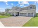 Charming two-story home featuring a three-car garage and beautifully landscaped front yard at 3179 Sailing Pier Ave, Winter Garden, FL 34787