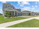 Charming two-story home featuring a three-car garage and beautifully landscaped front yard at 3179 Sailing Pier Ave, Winter Garden, FL 34787