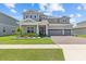 Charming two-story home featuring a three-car garage and beautifully landscaped front yard at 3179 Sailing Pier Ave, Winter Garden, FL 34787