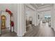 Wide hallway featuring wood floors, decorative columns, and access to multiple living areas at 3179 Sailing Pier Ave, Winter Garden, FL 34787