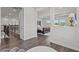 Upstairs hallway with view into the main bedroom, featuring a large wooden bed and tray ceiling at 3179 Sailing Pier Ave, Winter Garden, FL 34787