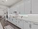 Stylish kitchen boasting custom cabinets, quartz countertops, modern appliances, and ample storage at 3179 Sailing Pier Ave, Winter Garden, FL 34787