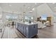 Open concept kitchen with island, stainless steel appliances, and a seamless flow into the living room at 3179 Sailing Pier Ave, Winter Garden, FL 34787