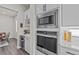 Convenient kitchen features built-in microwave, wine storage and cooler, and stone countertops at 3179 Sailing Pier Ave, Winter Garden, FL 34787