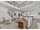 Cozy living room featuring a two-story ceiling, open layout, and views into the kitchen at 3179 Sailing Pier Ave, Winter Garden, FL 34787