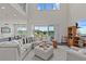 Bright living room with high ceilings, large sectional sofa, and view to the backyard at 3179 Sailing Pier Ave, Winter Garden, FL 34787