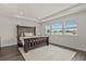 Bright and airy main bedroom featuring a wooden bed frame and tray ceiling at 3179 Sailing Pier Ave, Winter Garden, FL 34787