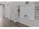 Well-organized mudroom with custom built-ins, shelving, and hooks for storage at 3179 Sailing Pier Ave, Winter Garden, FL 34787