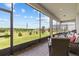 Enjoy the peaceful screened-in patio with brick flooring and an expansive view of the green backyard at 3179 Sailing Pier Ave, Winter Garden, FL 34787