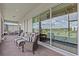 Covered patio with stylish outdoor furniture and retractable shades at 3179 Sailing Pier Ave, Winter Garden, FL 34787