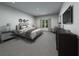 Bedroom with modern lighting, a comfortable bed, carpet flooring, and simple decor at 3674 Portsmouth Ln, Haines City, FL 33844