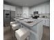 Kitchen with an island, granite countertops, stainless steel appliances, and modern barstool seating at 3674 Portsmouth Ln, Haines City, FL 33844