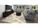 Cozy living room with neutral-toned sofas, a decorative rug, and a large TV screen at 3674 Portsmouth Ln, Haines City, FL 33844
