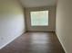 Bedroom with wood laminate flooring, neutral paint, and a large window for natural light at 3713 S Lake Orlando Pkwy # 6, Orlando, FL 32808